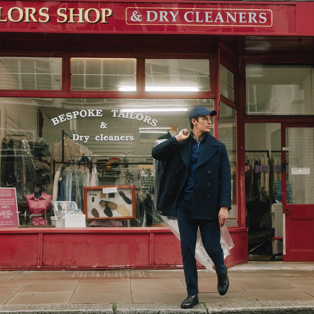 Man walking out of a dry cleaners
