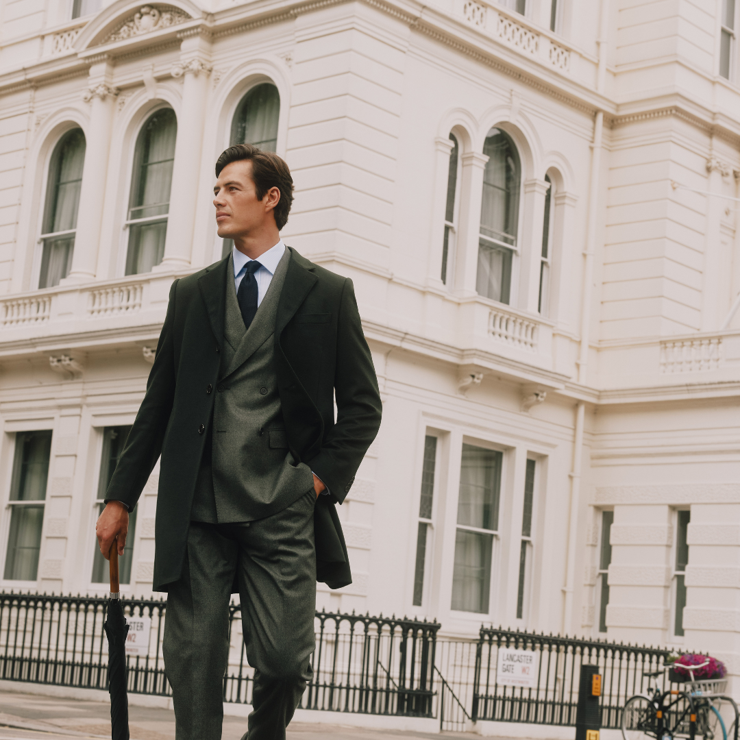 Man Holding an Umbrella in a Hawes and Curtis Suit