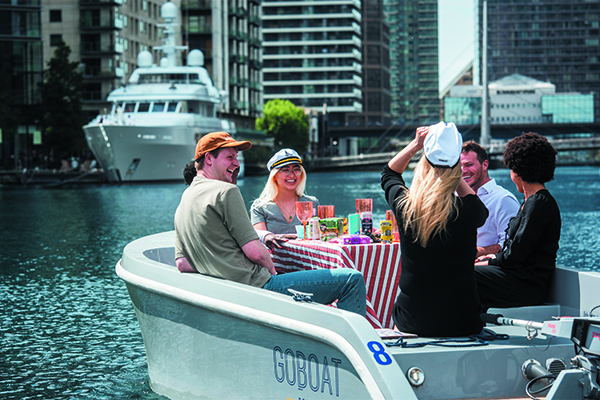 People in a self-drive boat in Canary Wharf