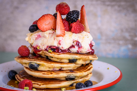 Pancake stack with strawberries and cream