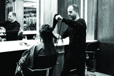 Woman sitting in a hairdressers having a blow dry