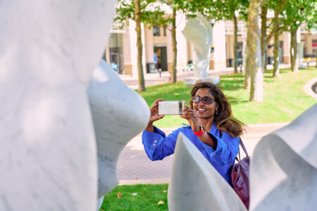 Woman taking a photo of a sculpture