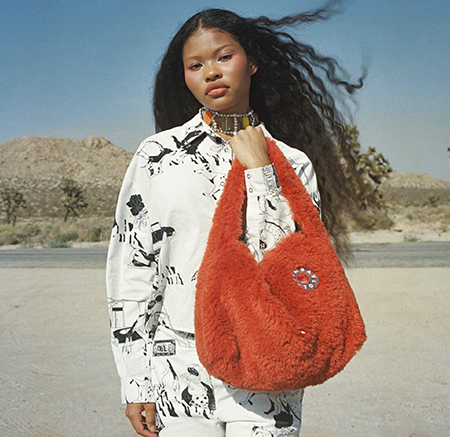 Woman carrying an orange handbag