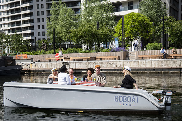 People in a self-drive boat in Canary Wharf