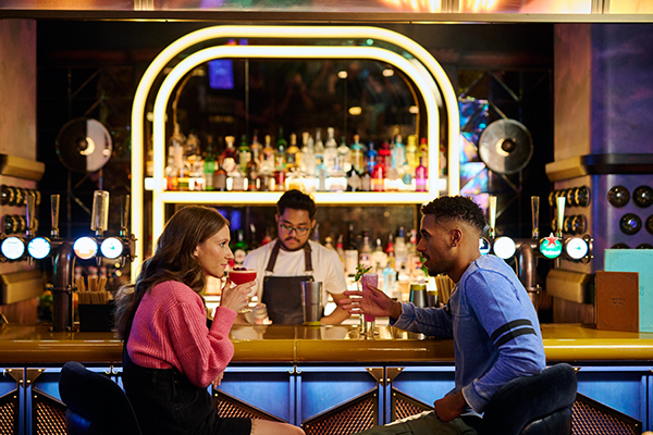 Couple sitting at the bar in Electric Shuffle