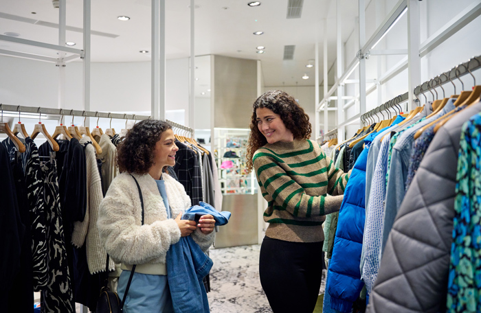 Customers looking through clothes in a clothing store