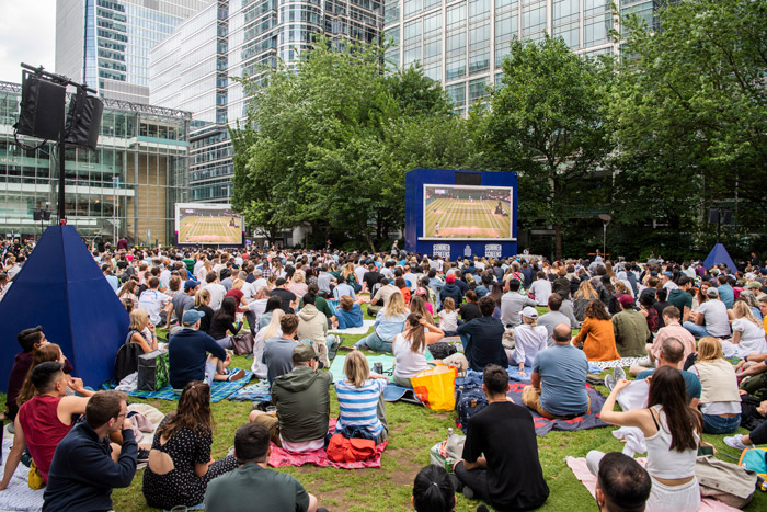 People watching a Wimbledon match on the big Screens in Canada square park