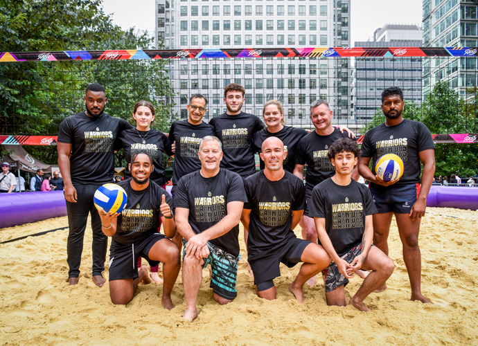 friends and colleagues playing beach volleyball