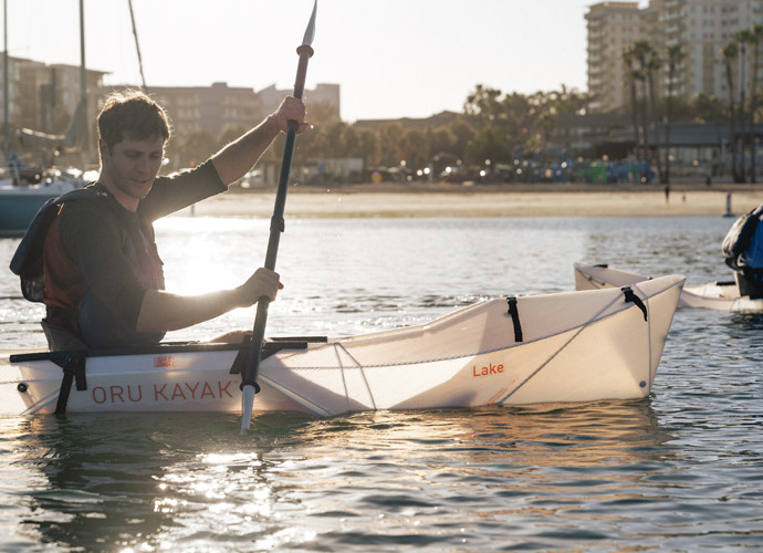 paddling through the water on Oru Kayak boat