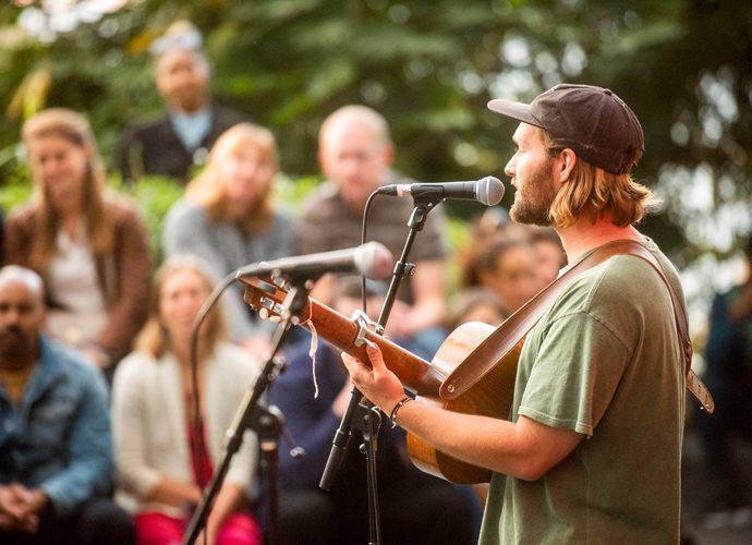 Singing to the crowd with a guitar