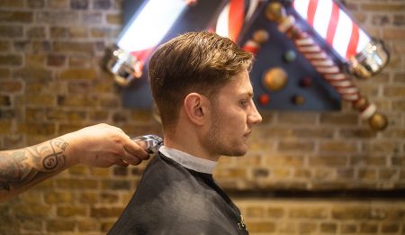 boy getting hair cut in teds grooming