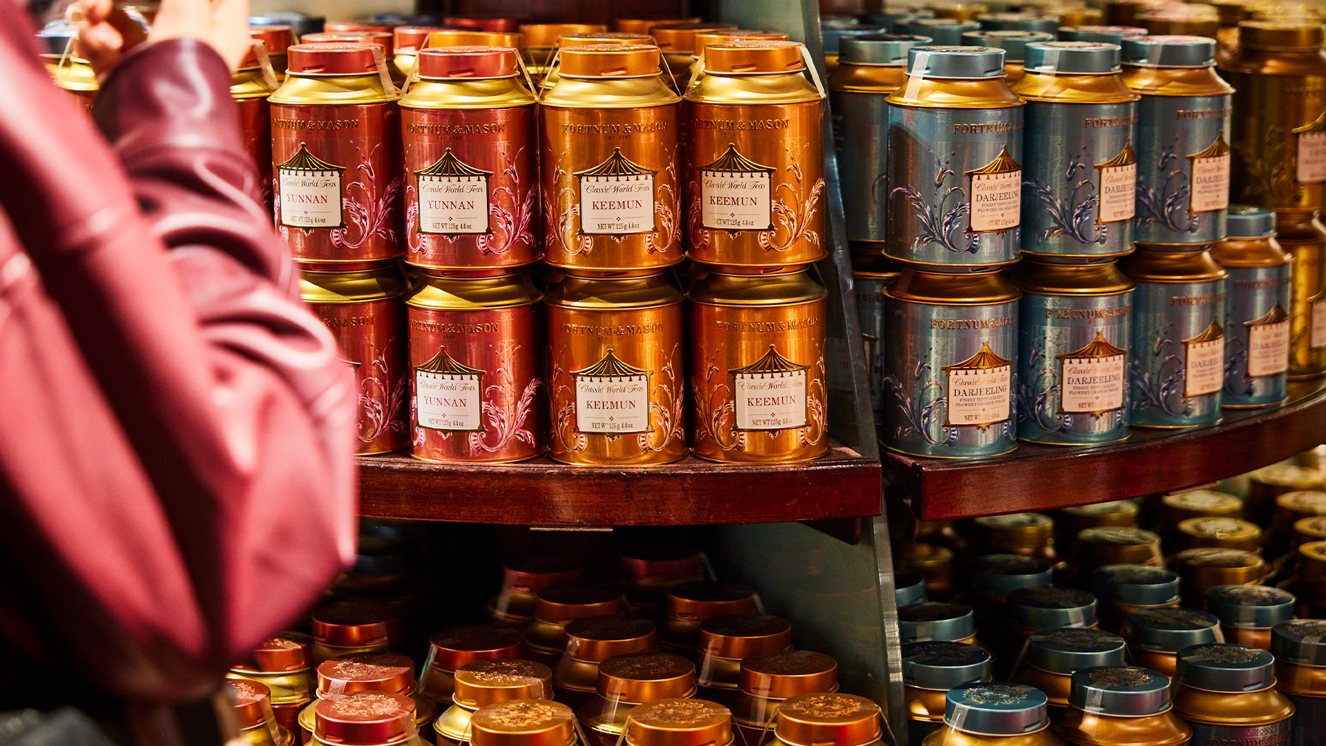 Person picking up fortnum & mason tin