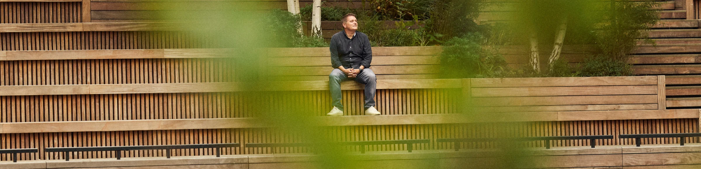 man sitting on bench looking to the right