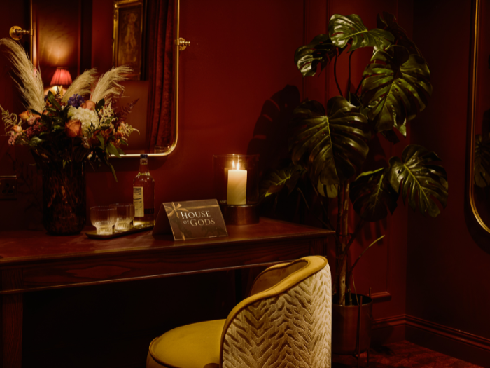 Vanity table and chair with flowers and a plant