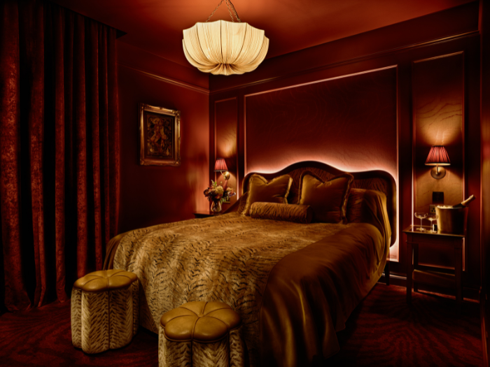 Bed in room with tiger print blanket and ambient lighting