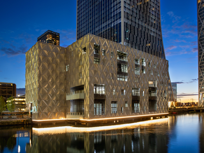 Exterior of building with lighting reflecting on water