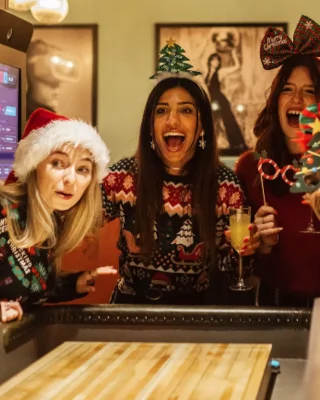 People in Christmas Decorations playing shuffle board