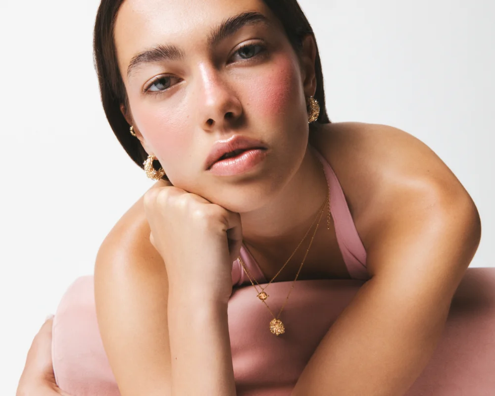 women with pink dress and gold jewellery on