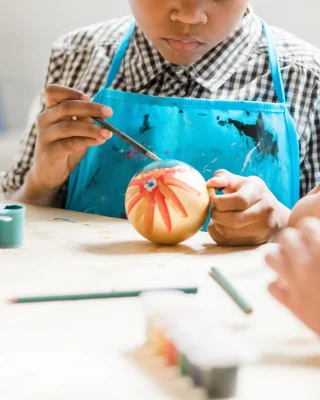 Child painting a christmas decoration