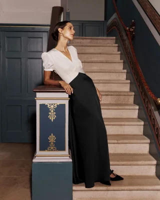 Women standing on stairs in black tie dress