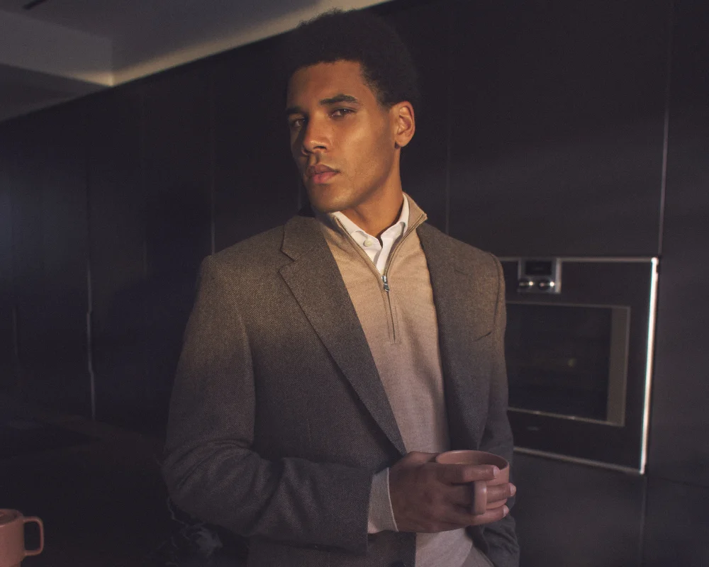 man in suit with quarter zip jumper