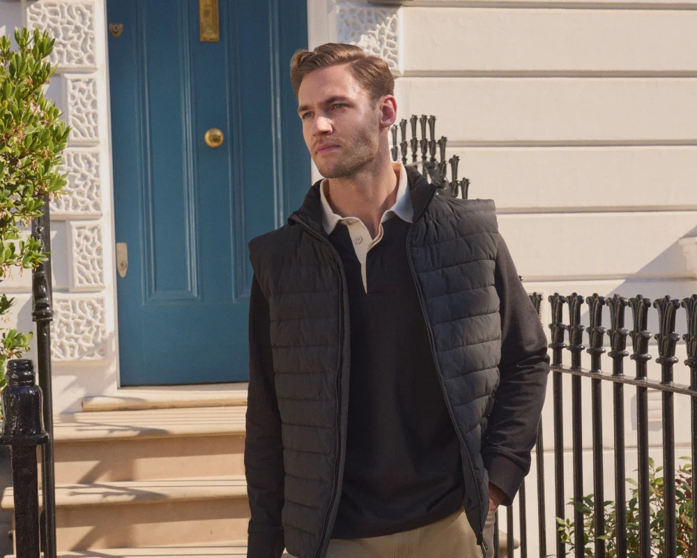 man in gilet and polo shirt