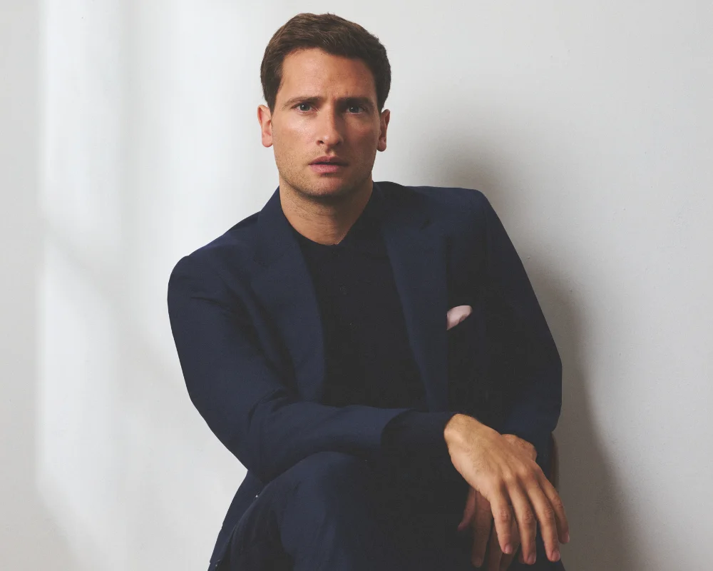 man in suit posing with white background