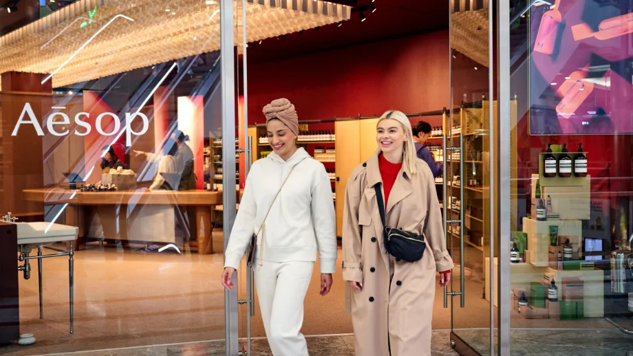 two girls walking out of Aesop