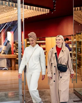 two girls walking outside of aesop