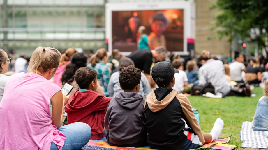 children watching cinema screen outdoor