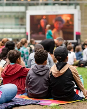 child watching outdoor cinema screens