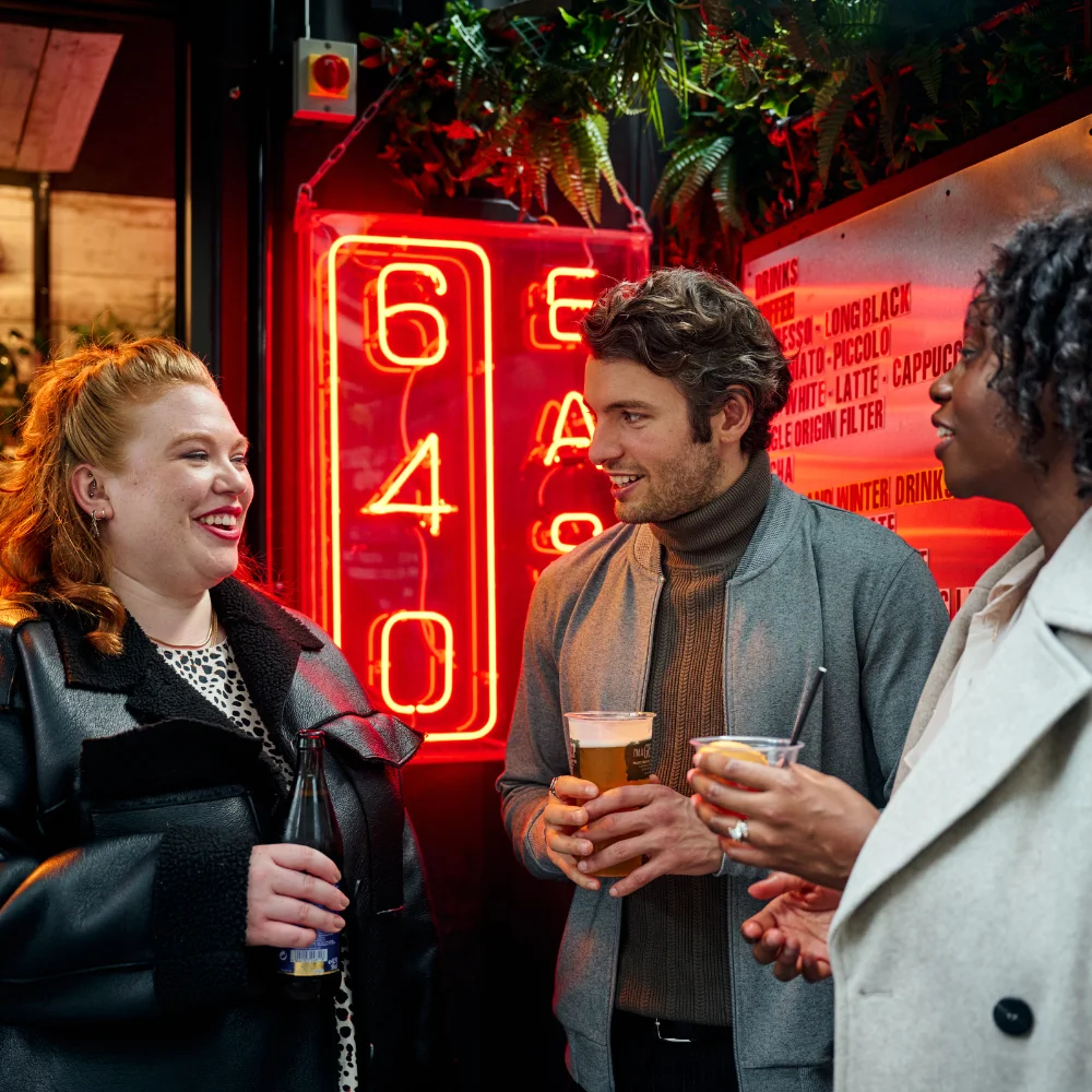 people standing outside pub drinking